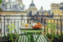 table with French food on balcony overlooking Paris skyline