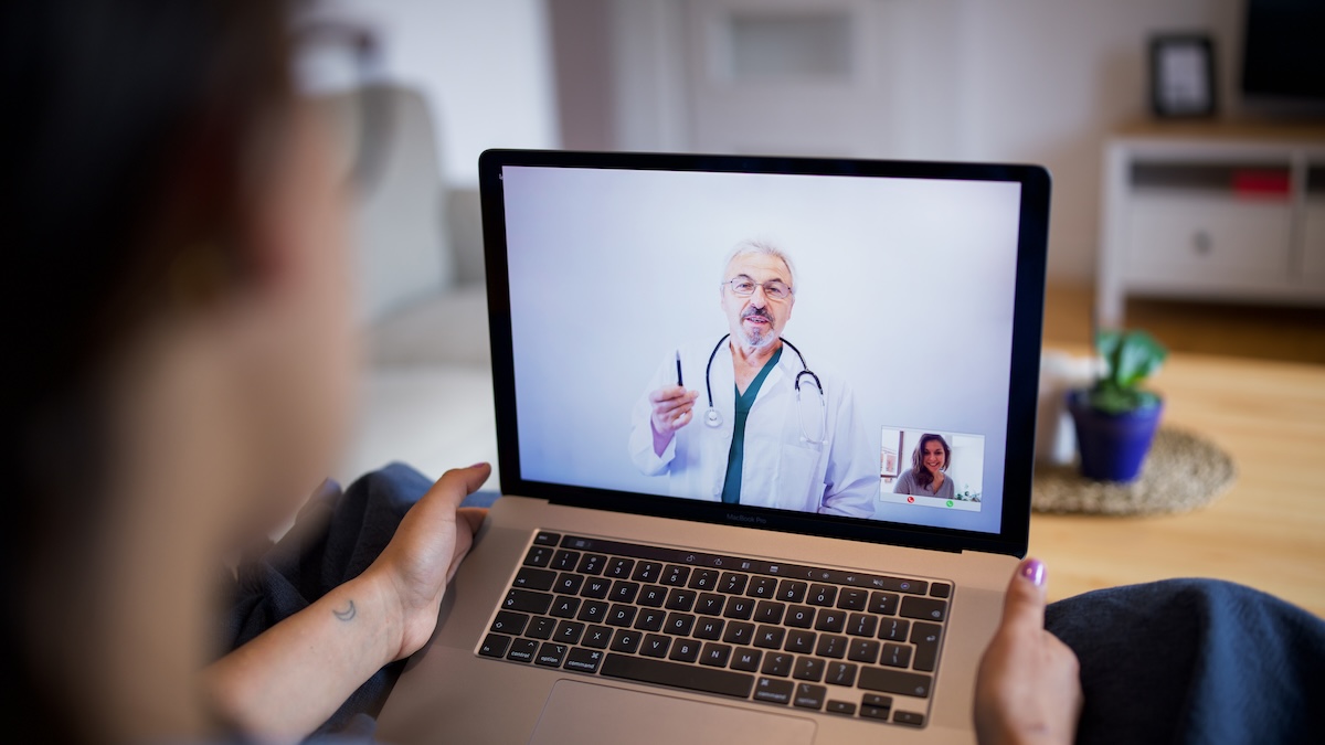 Young Woman Is Having Online Medical Consultation With Her Male Healthcare Person