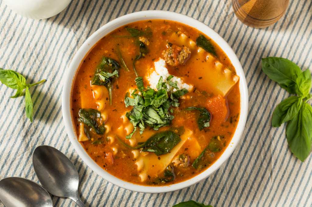 homemade lasagna soup with fresh basil and ricotta in bowl