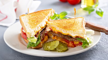 Patty melt featuring a burger and cheese between two toasted slices of bread
