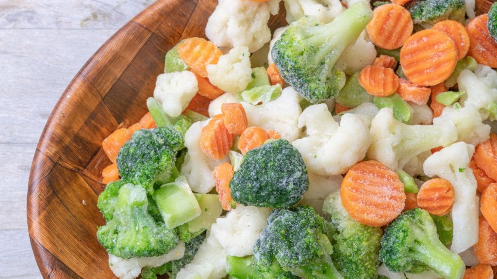 Mixed frozen vegetables on a bowl, top view
