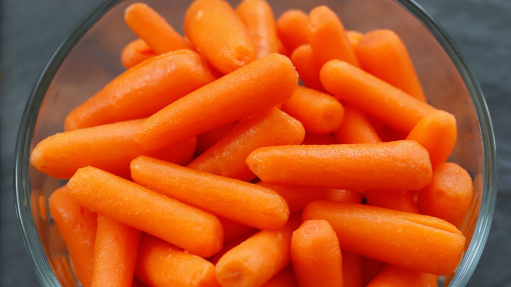 Clear bowl of baby carrots