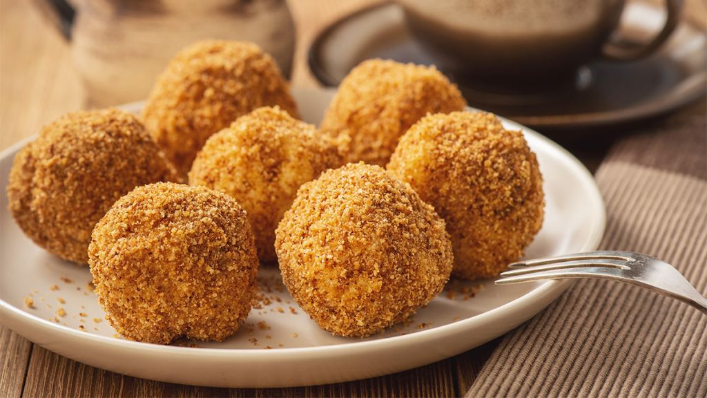 Fried cheesecake bites on a plate