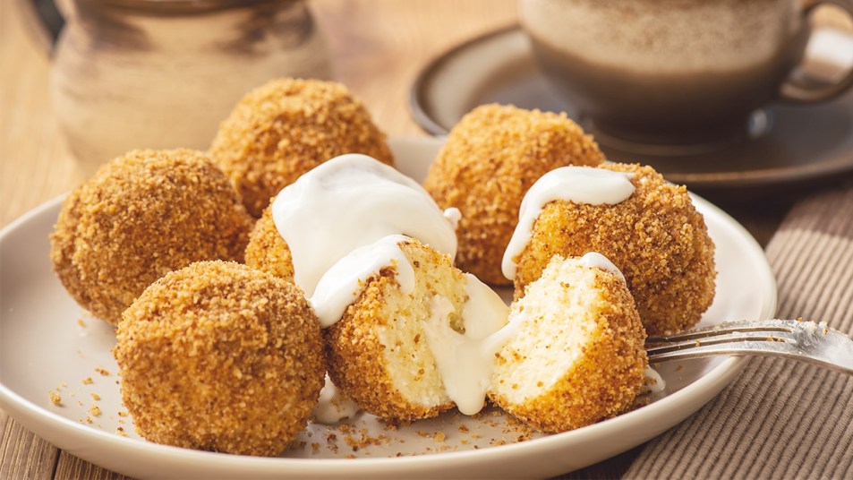 Fried cheesecake with sweet creme fraiche sauce poured over them