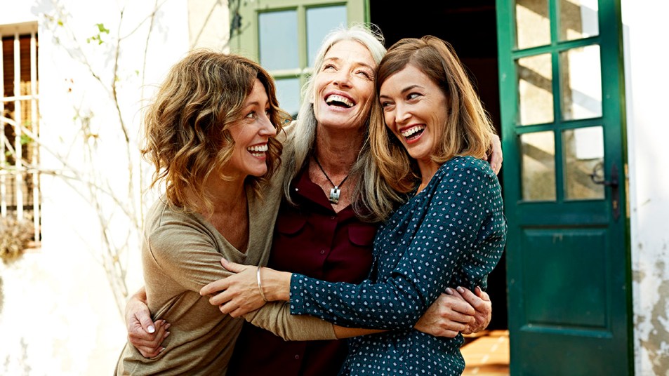 Three adult woman who look to be found family hugging as described in a book