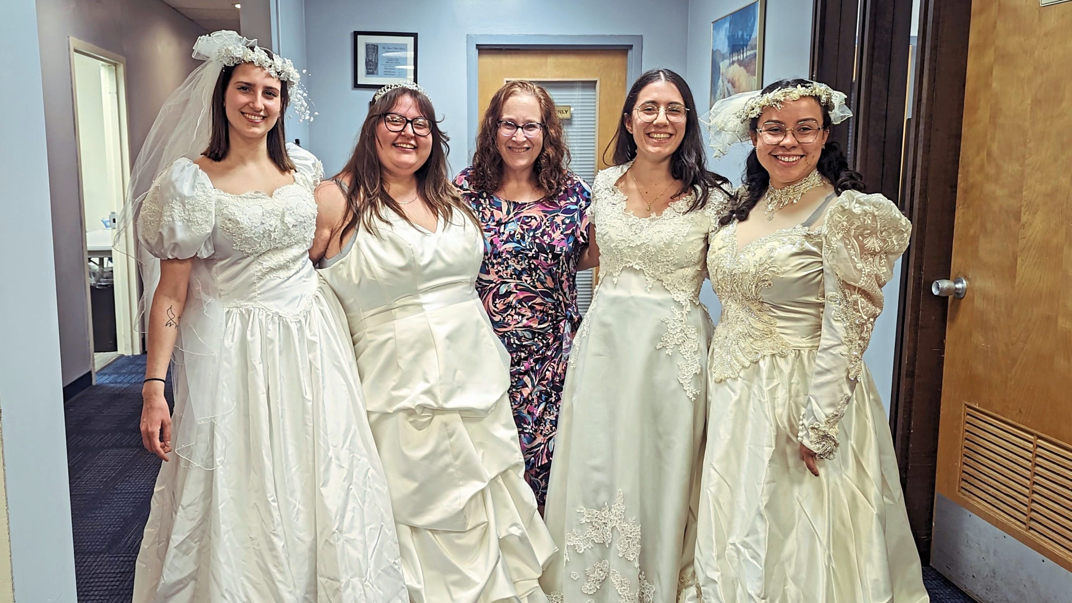 Librarian Adele Puccio (center) with brides who got her dresses