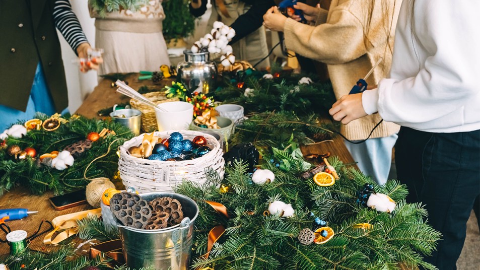 women around a table with wreath supplies; wreaths making party