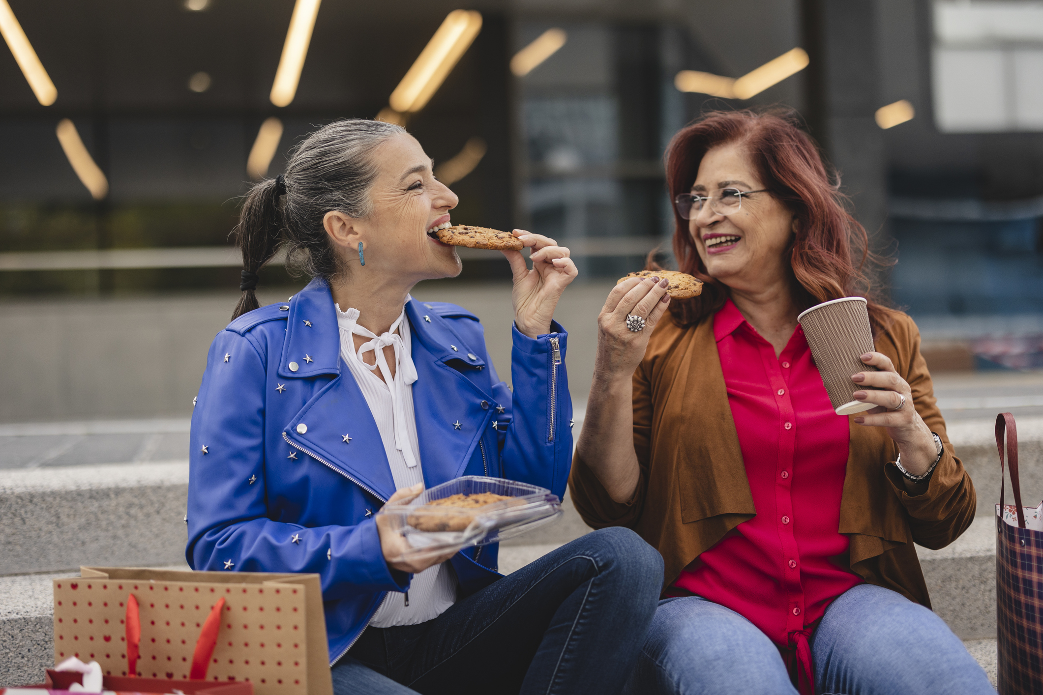 two mature woman out shopping during Black Friday and Cyber Monday enjoying food deals