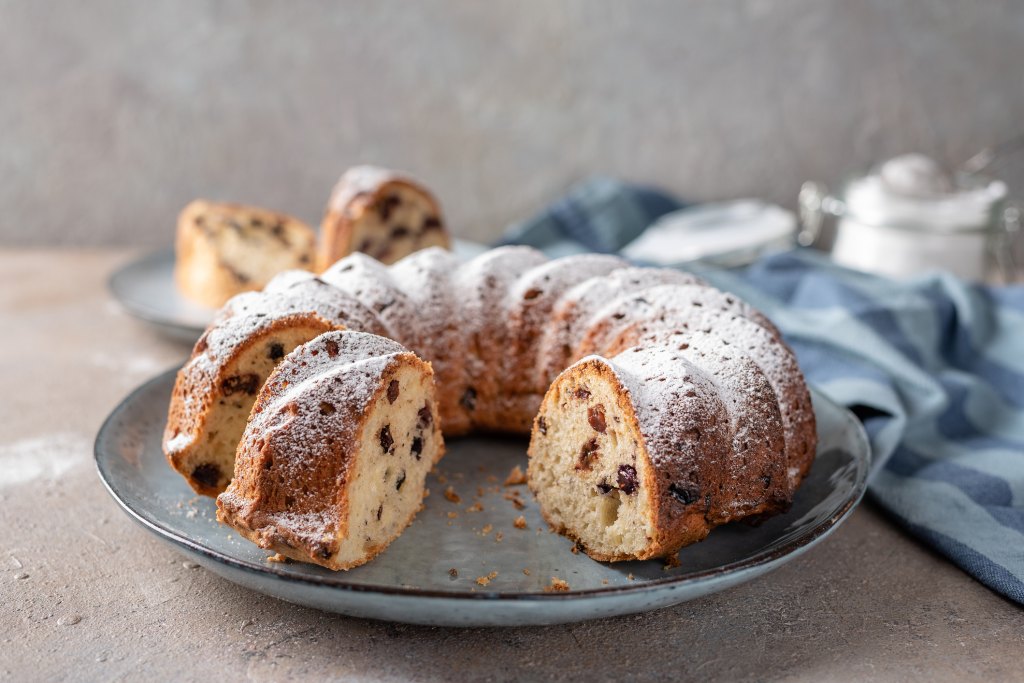 cut election cake with raisins and powdered sugar dusting on plate