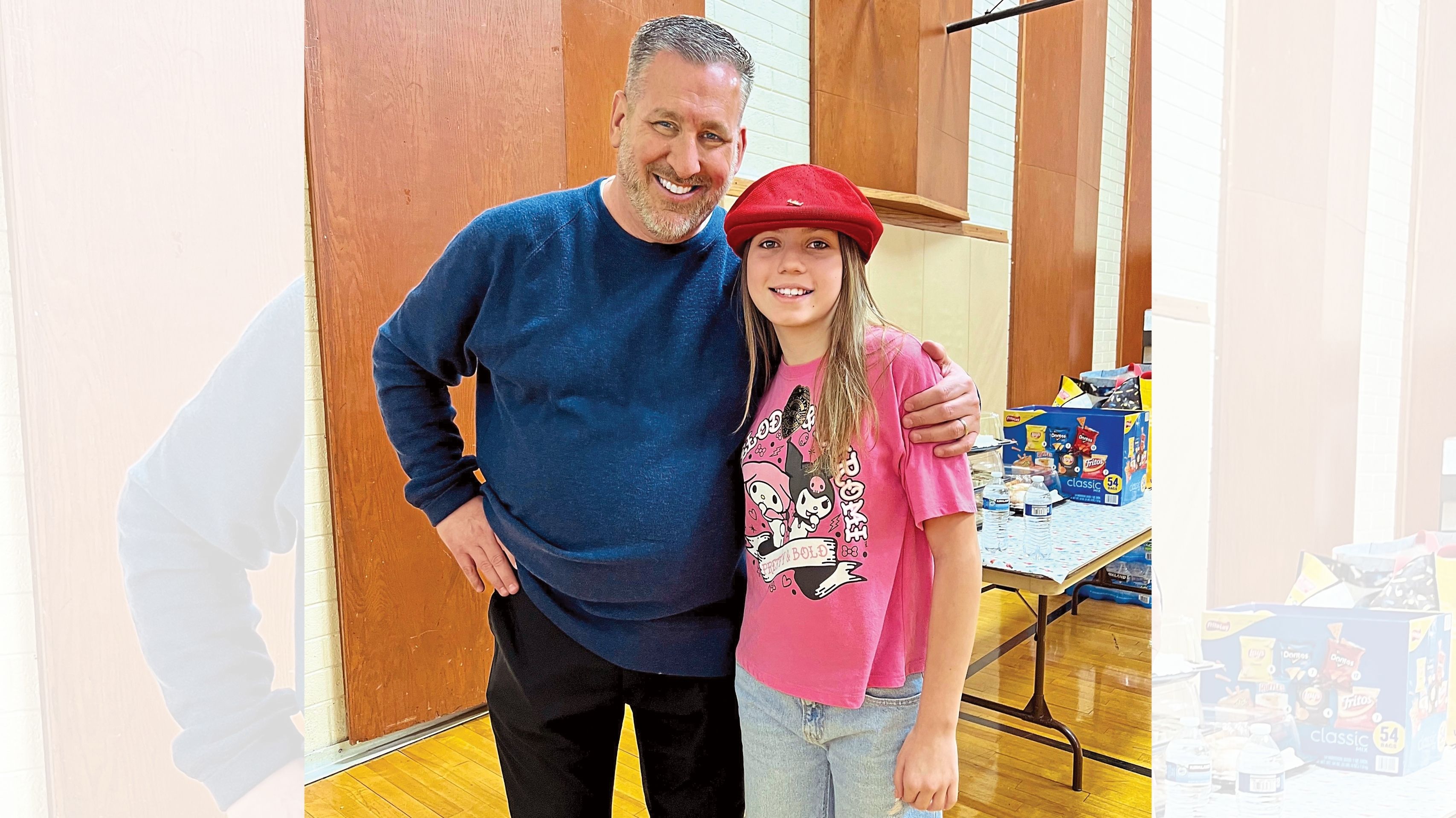Derek Brown (left) inspired his fifth graders to give $100 bills to people in need