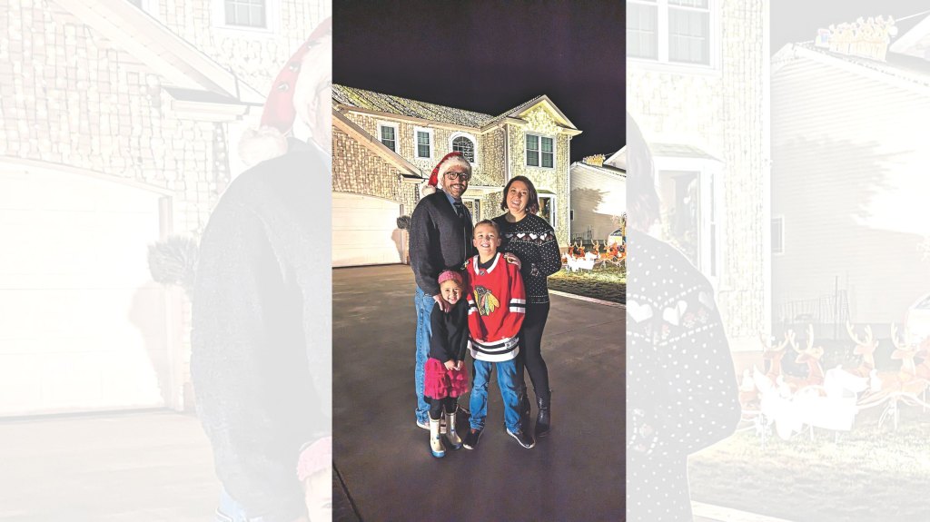 “It’s a way of illuminating people’s lives,” says Greg (left) with his family