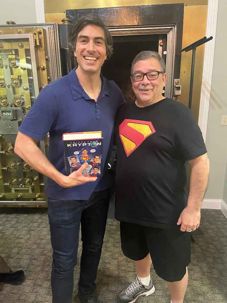 Brandon Routh, holding a copy of Voices from Krypton, which he wrote the foreword to), with Ed Gross