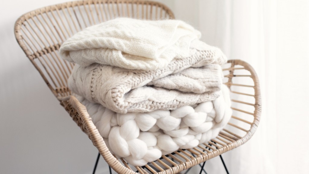 Stacking blankets on a chair is one of many blanket storage ideas