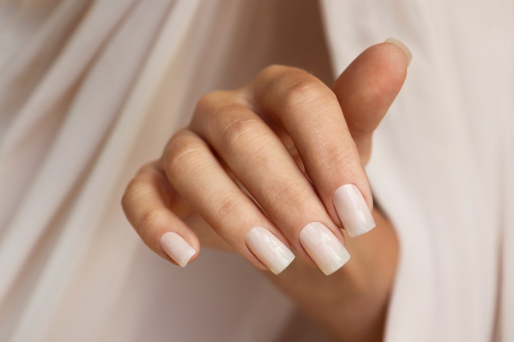 A woman with square nails, which is one of the top nail shapes 2023