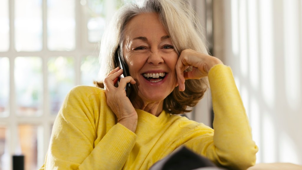 A happy woman talking on the phone