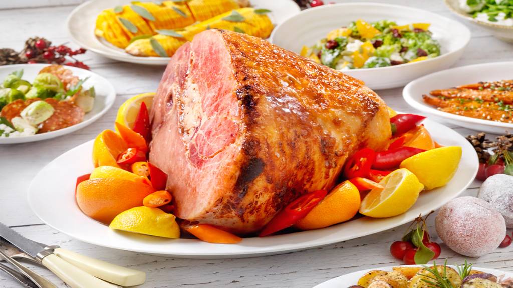 A pineapple-rum glazed ham served as part of a holiday dinner spread
