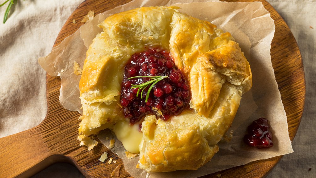 Puff pastry baked brie topped with cranberry sauce