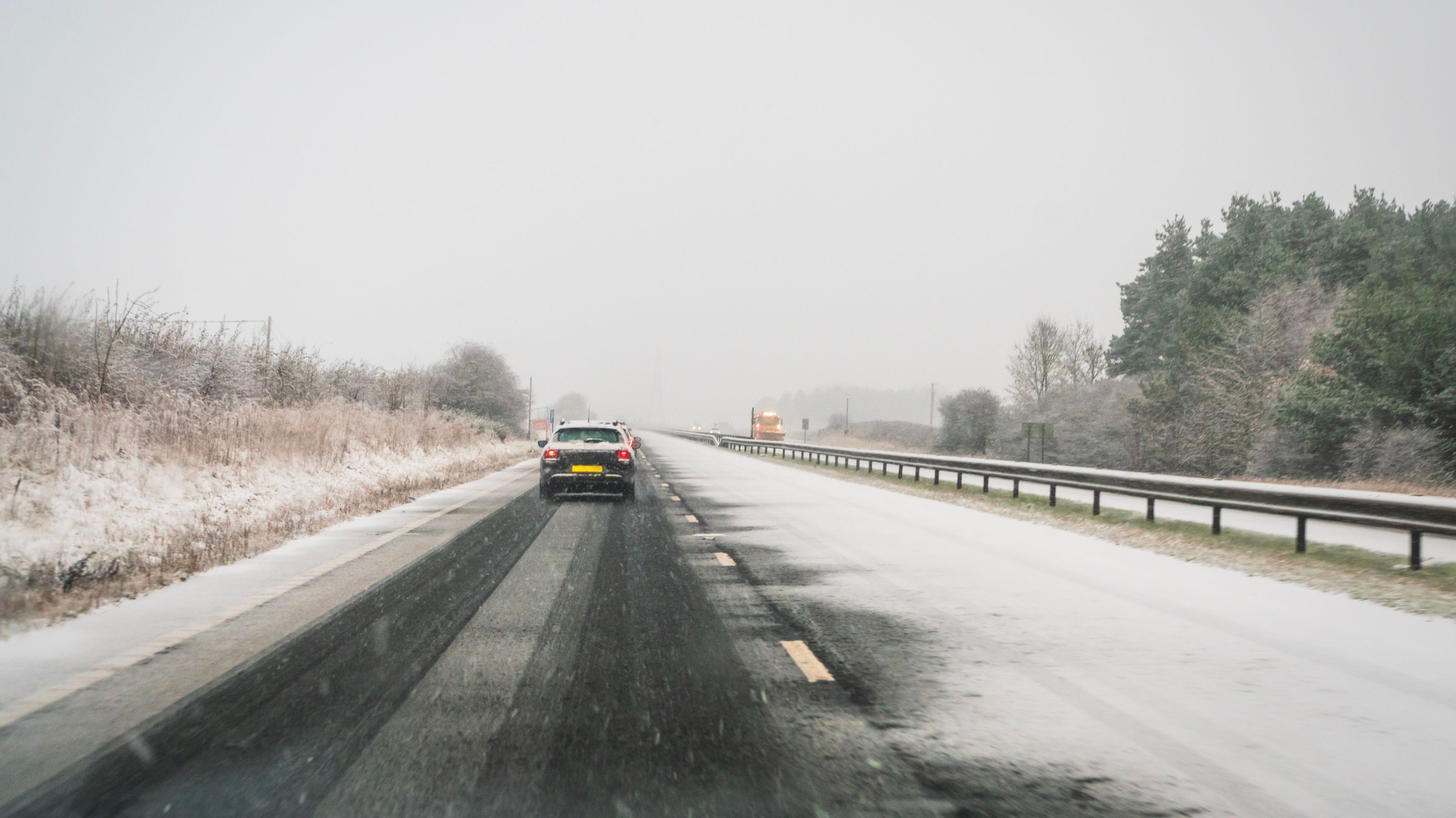 car in the snow on the highway