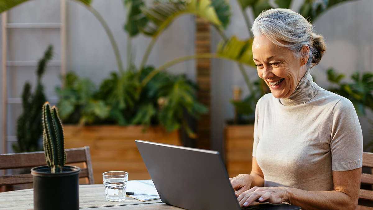 mature woman chatting on her laptop for her chat work from home jobs