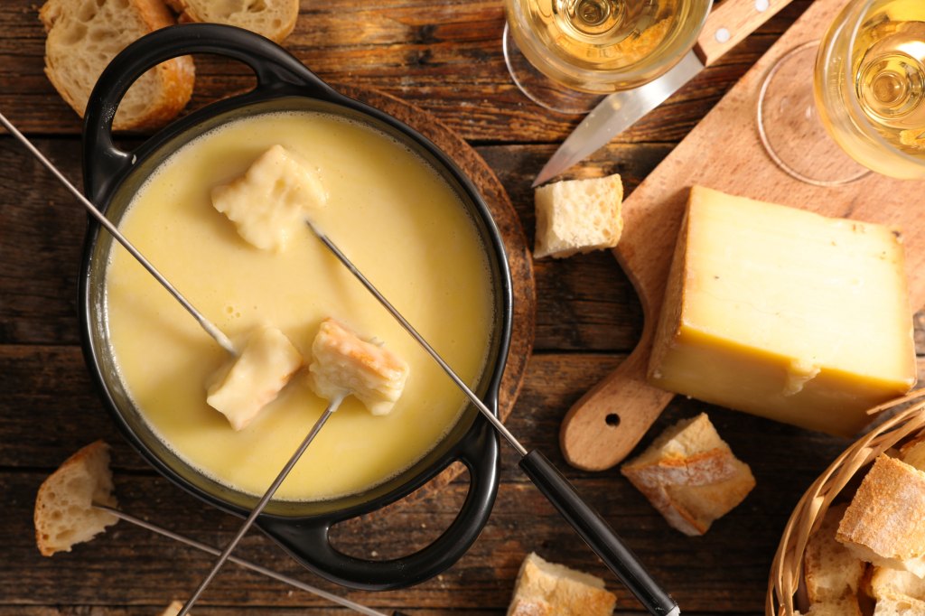 cheese fondue bar with bread on skewers dipped in