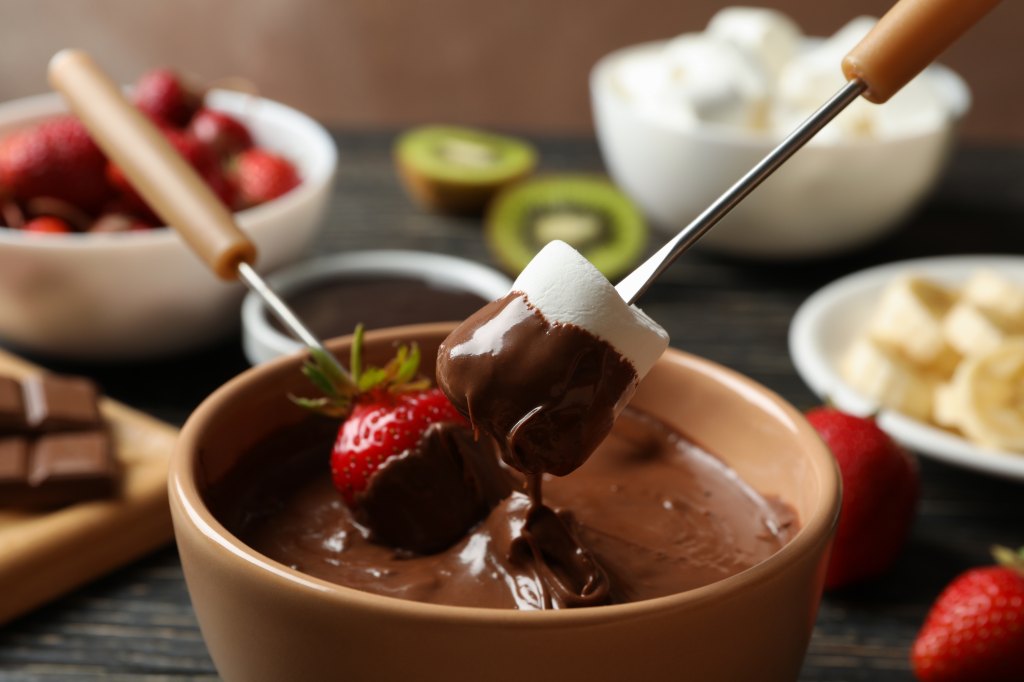 chocolate fondue bar with strawberries and marshmallows on skewers