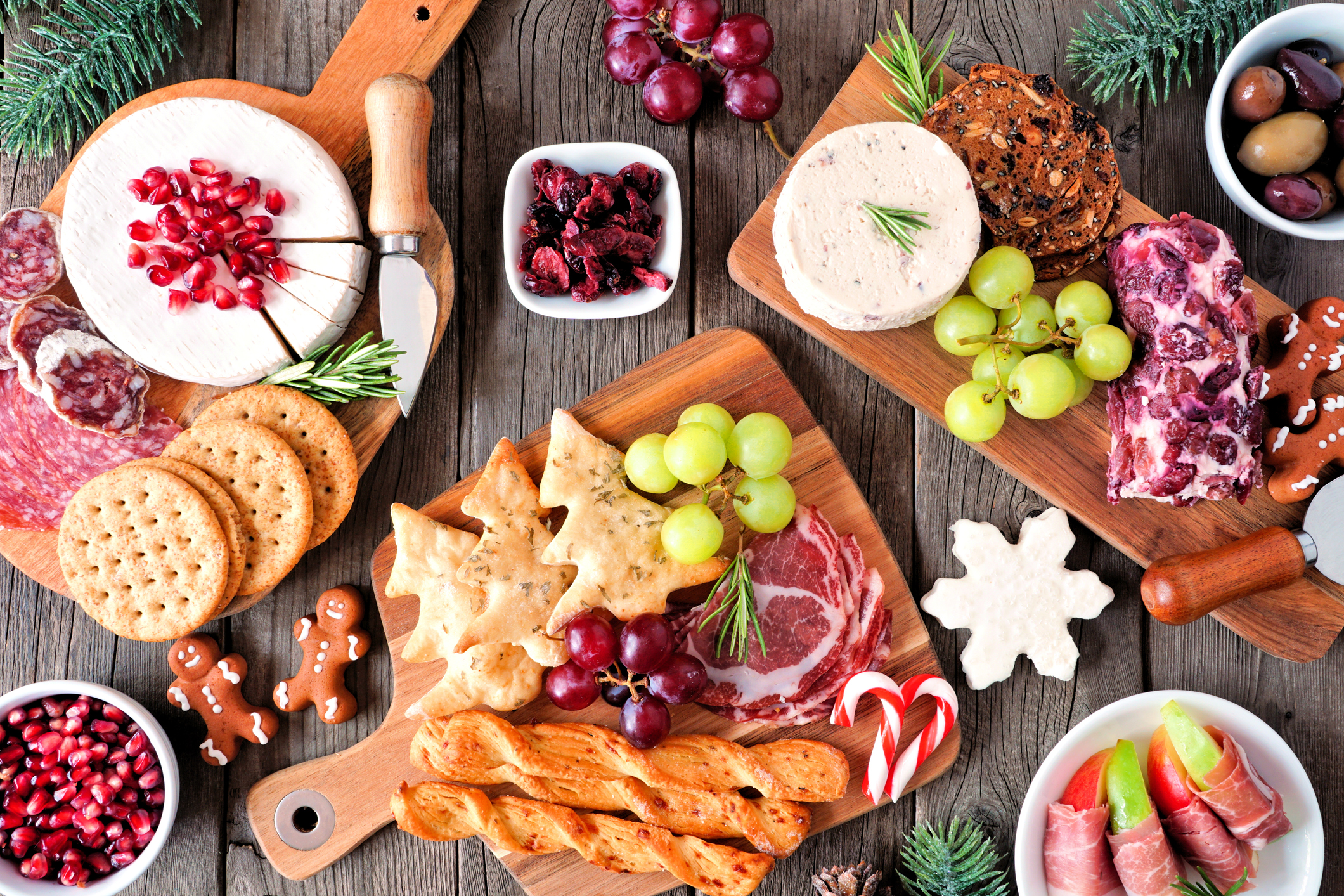 Christmas themed holiday charcuterie board table scene against dark wood