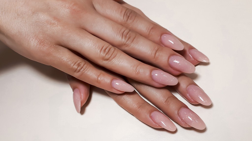 Woman with almond nails, which is one of the top nail shapes 2023
