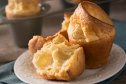 A fresh baked plate of popovers in two exposing the interior bread on plate