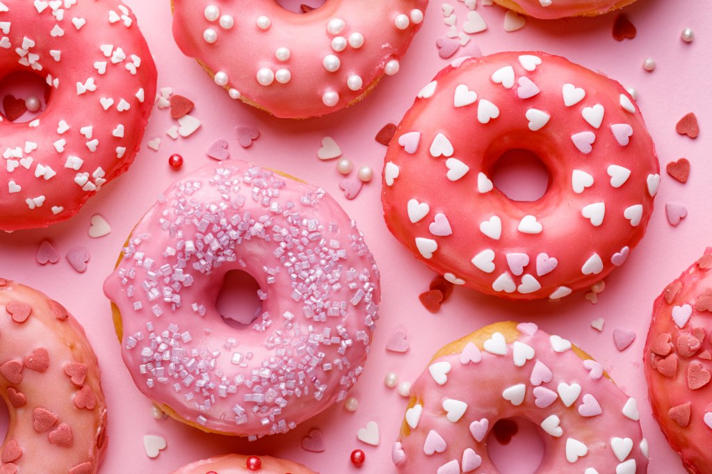 Sweet donuts with pink glaze decorating sprinkles from Dunkin' winter menu