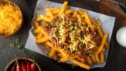 Homemade chili cheese fries with green onion and cheddar