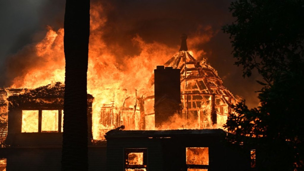 The Andrew McNally House, a historical landmark, burns during the Eaton Fire in Altadena, California, on January 8, 2025. Rampaging wildfires around Los Angeles have killed at least two people, officials said January 8 as terrifying blazes leveled whole streets, torching cars and houses in minutes. More than 1,000 buildings have burned in multiple wildfires that have erupted around America's second biggest city, forcing tens of thousands of people from their homes.