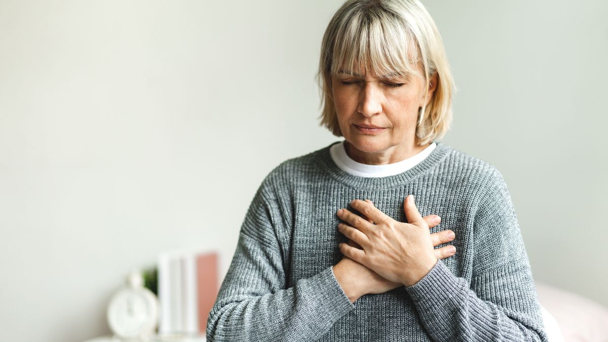 woman heaving chest pain along with other afib symptoms