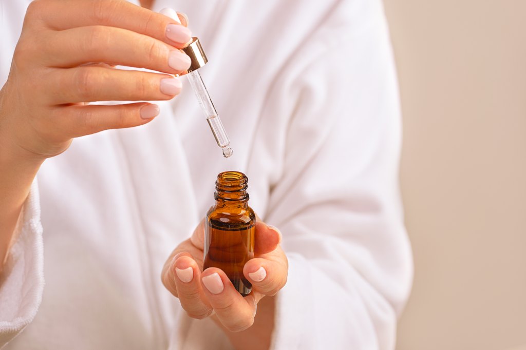 Woman holding a bottle of argan oil