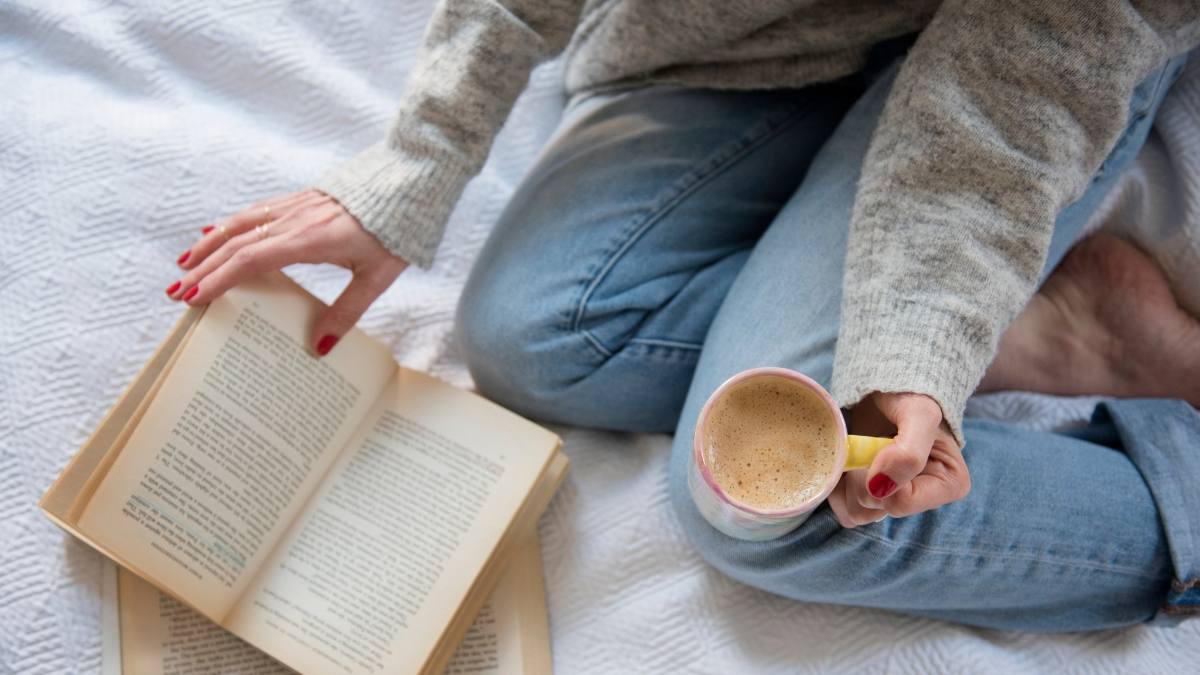 Woman reading multiple books