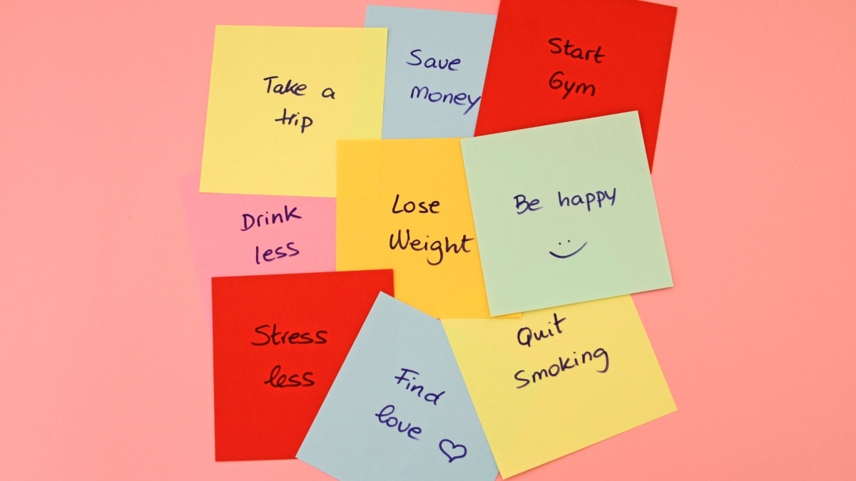 Colorful sticky notes with New Year's resolutions written on them