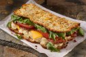 viral potato wrap breakfast sandwiches with egg, smoked turkey, cheese, tomato and arugula