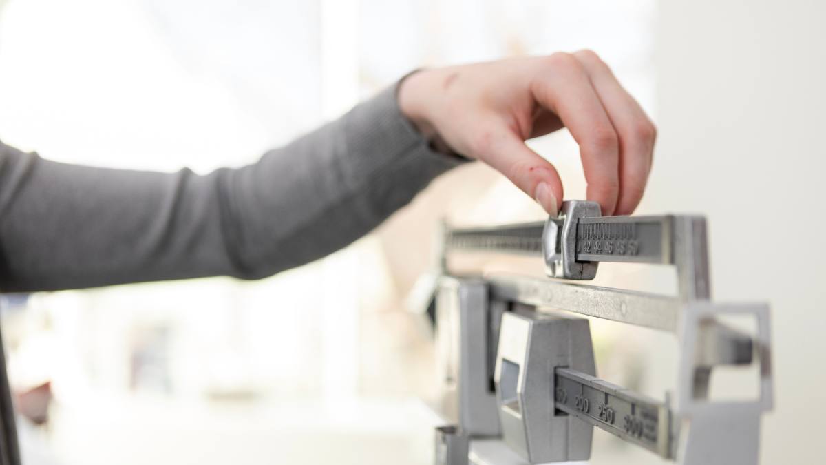 Woman adjusting scale