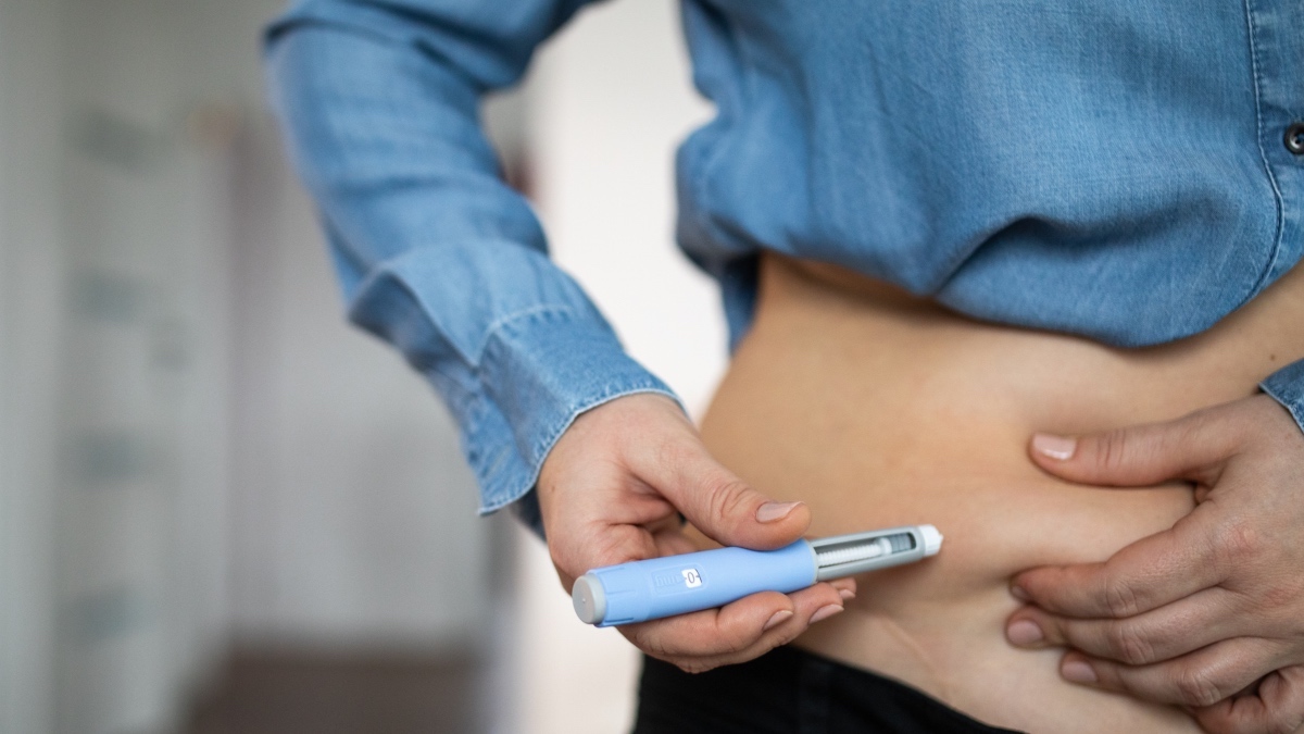 Woman using an Ozempic injection pen