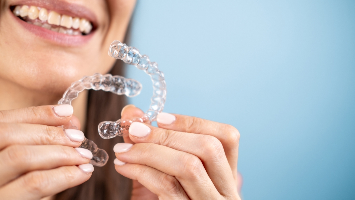 an older woman holding her pair of Invisalign alternatives