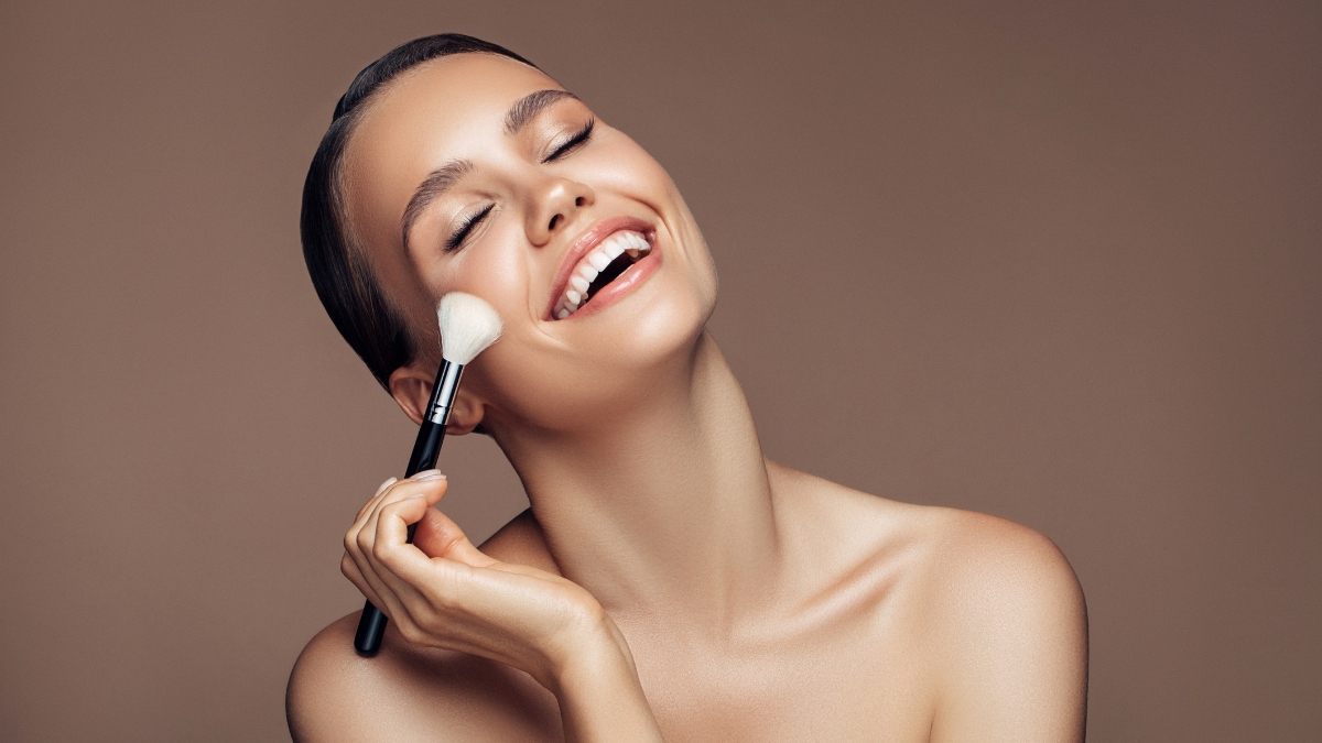 woman smiling after doing underpainting makeup technique
