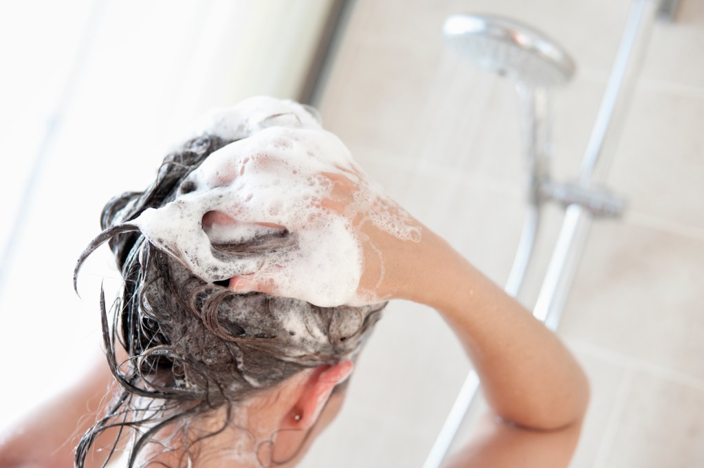 Woman washing hair and scalp