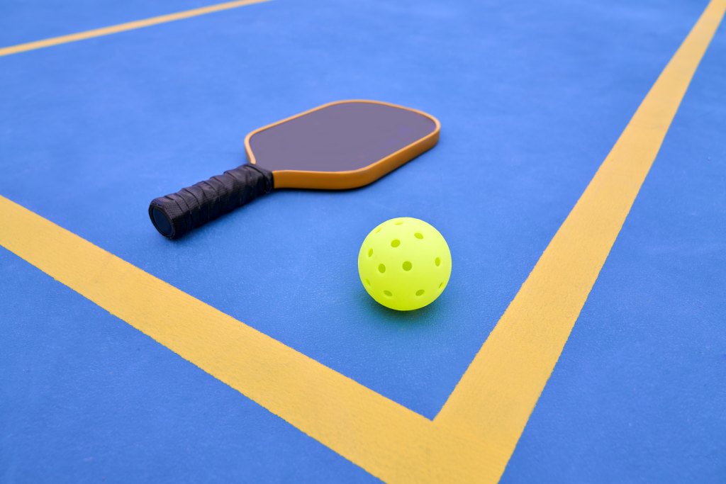 Pickleball Paddle and Ball on Pickle Ball Court