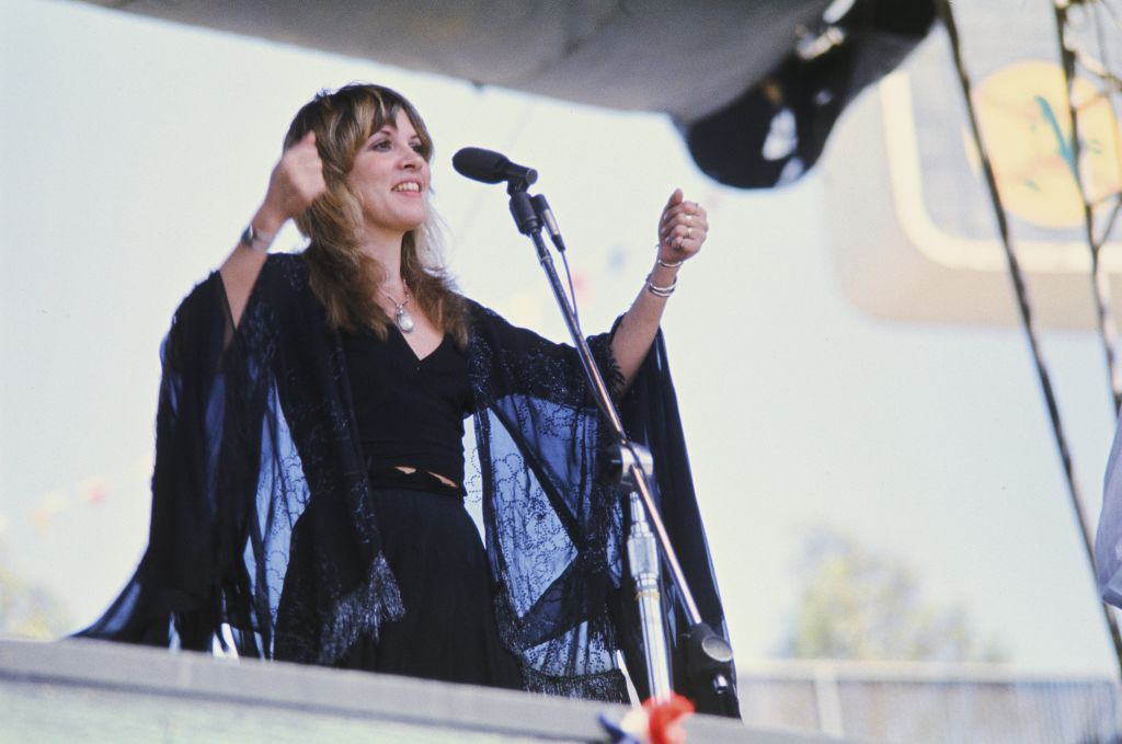 Stevie Nicks performing wearing black lace kimono