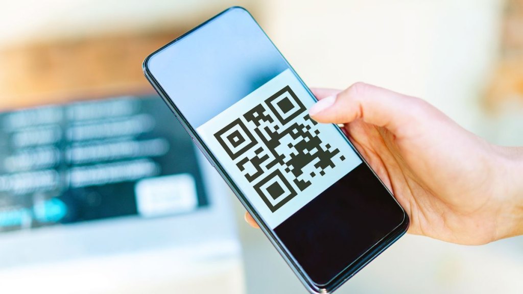 Horizontal top view of unrecognizable woman hand reading a digital encrypted code with technology