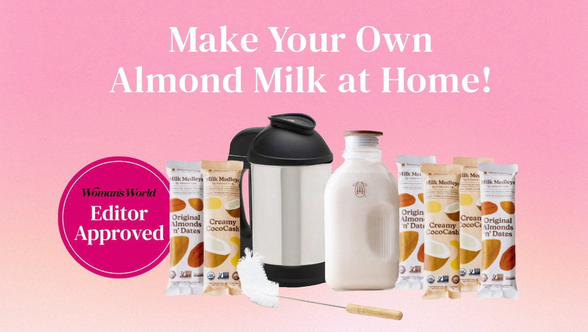 White text that reads 'Make Your Own Almond Milk at Home!' arranged on an ombre pink background. A picture of the Almond Cow Starter Kit is arranged in the center of the image with a hot pink call out that has the Woman's World logo and 'Editor Approved!' text.