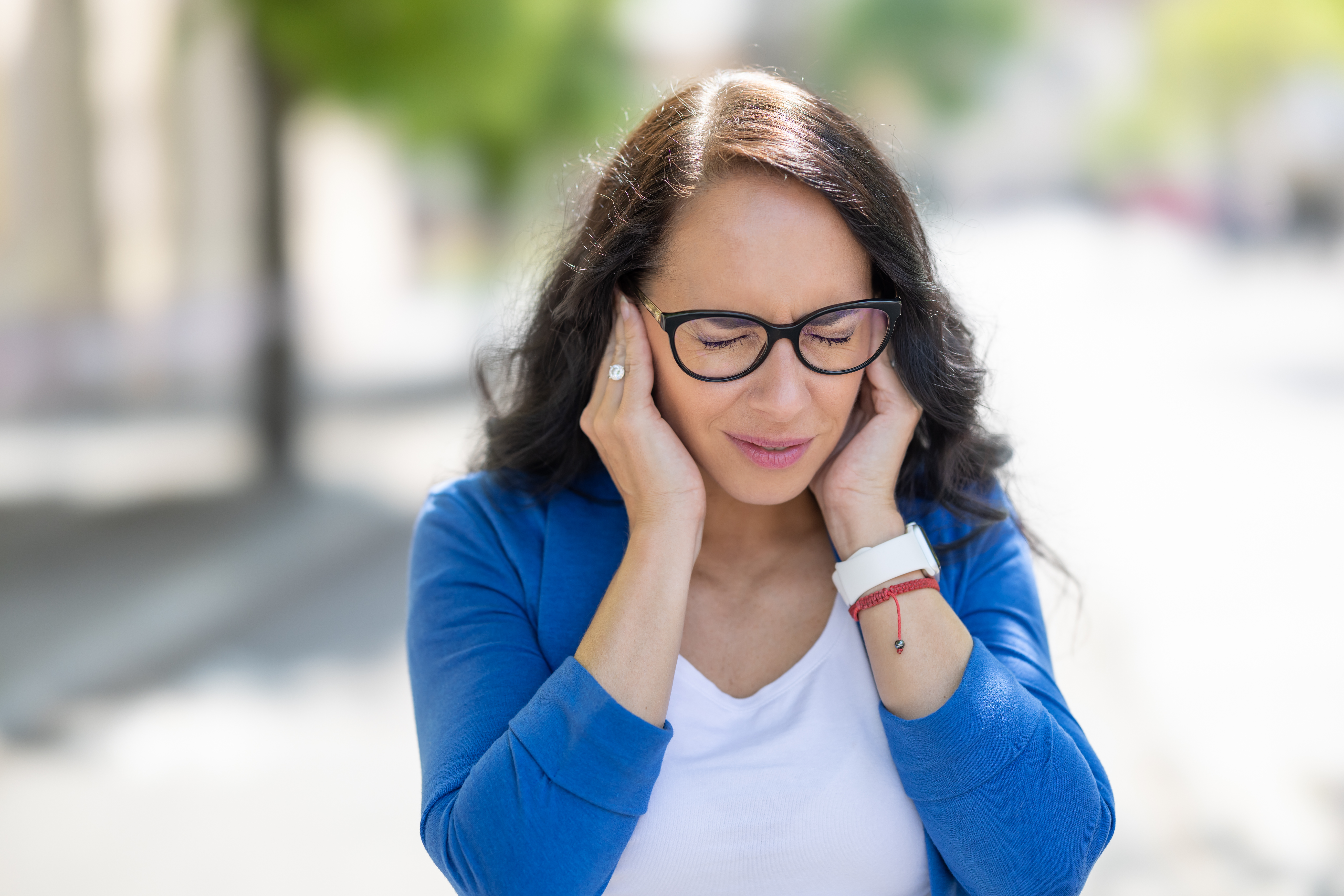 Woman holding both her ears