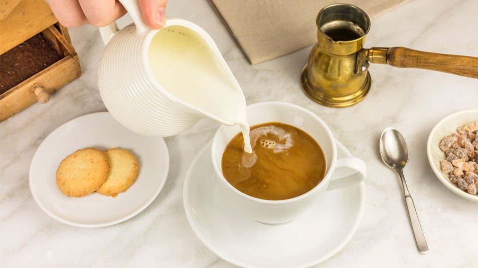 Person pouring homemade coffee creamer into coffee