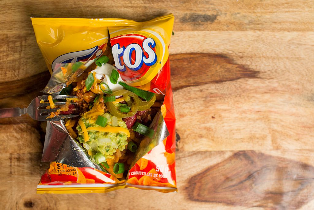 Frito pie in Frito chip bag on wooden surface