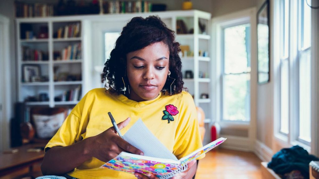 Black woman journaling