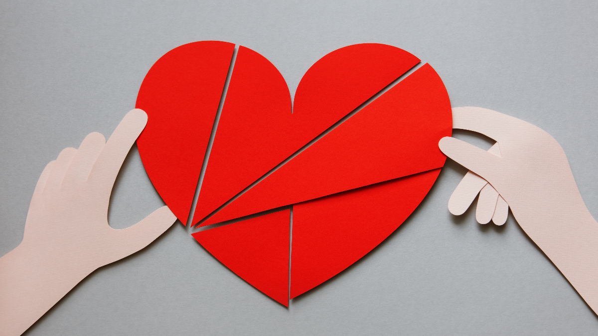 illustration of a red heart, divided into pieces and two hands putting it back together